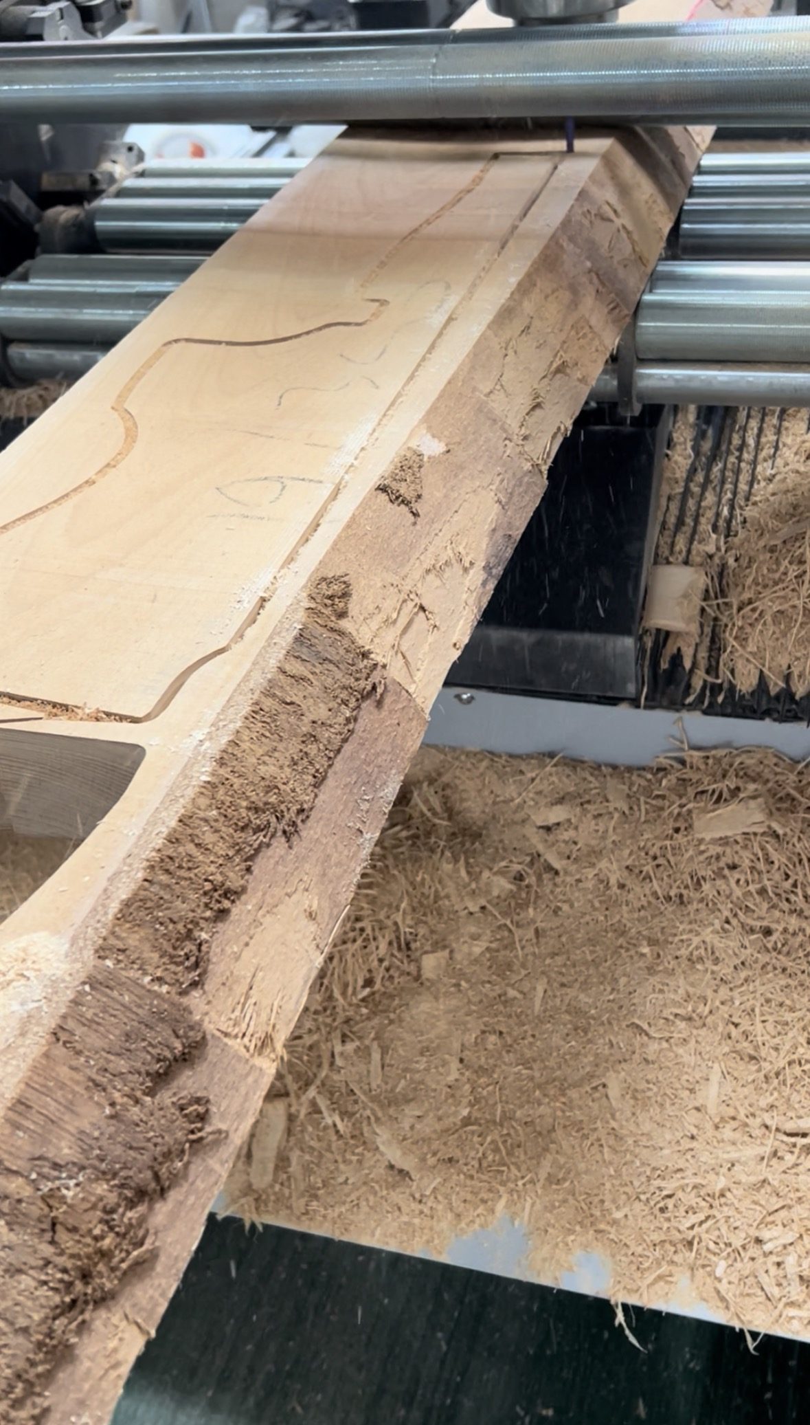 Rough beech board being cut according to the AI-generated layout