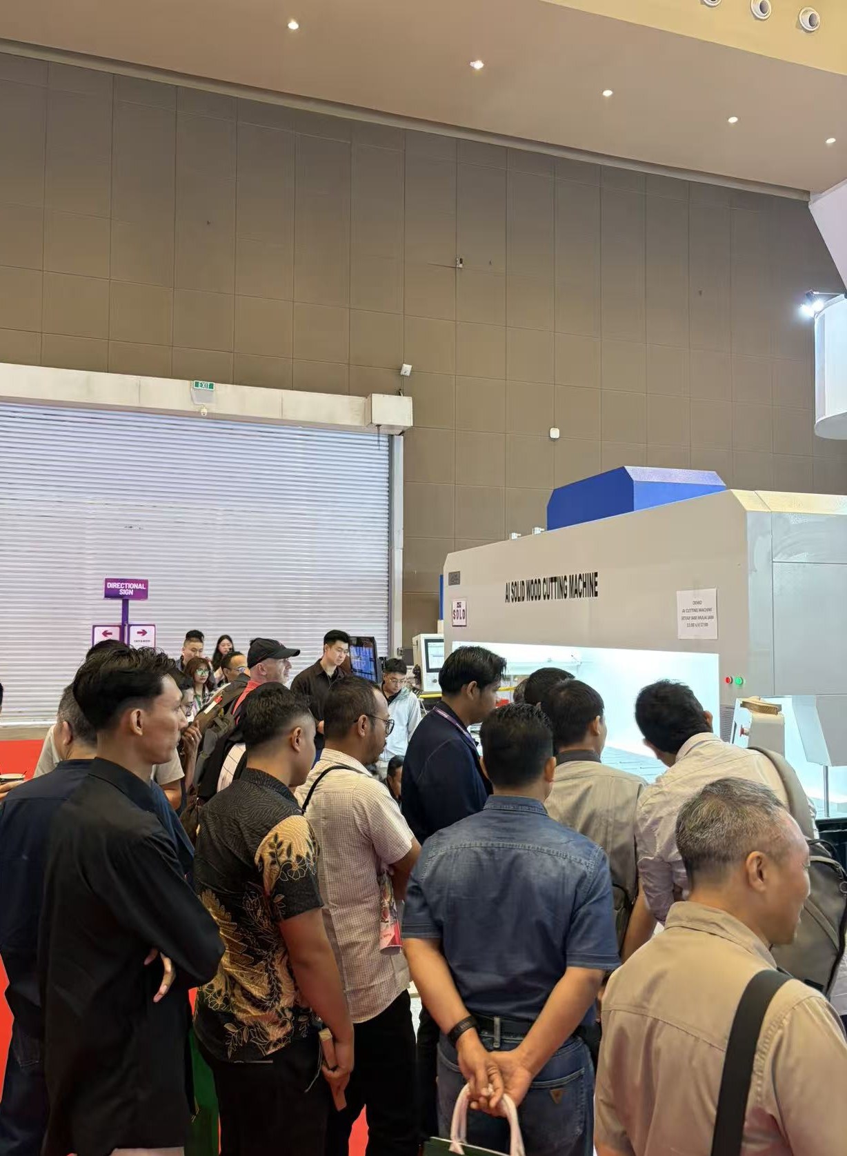 Visitors gather around the machine during a live demonstration.